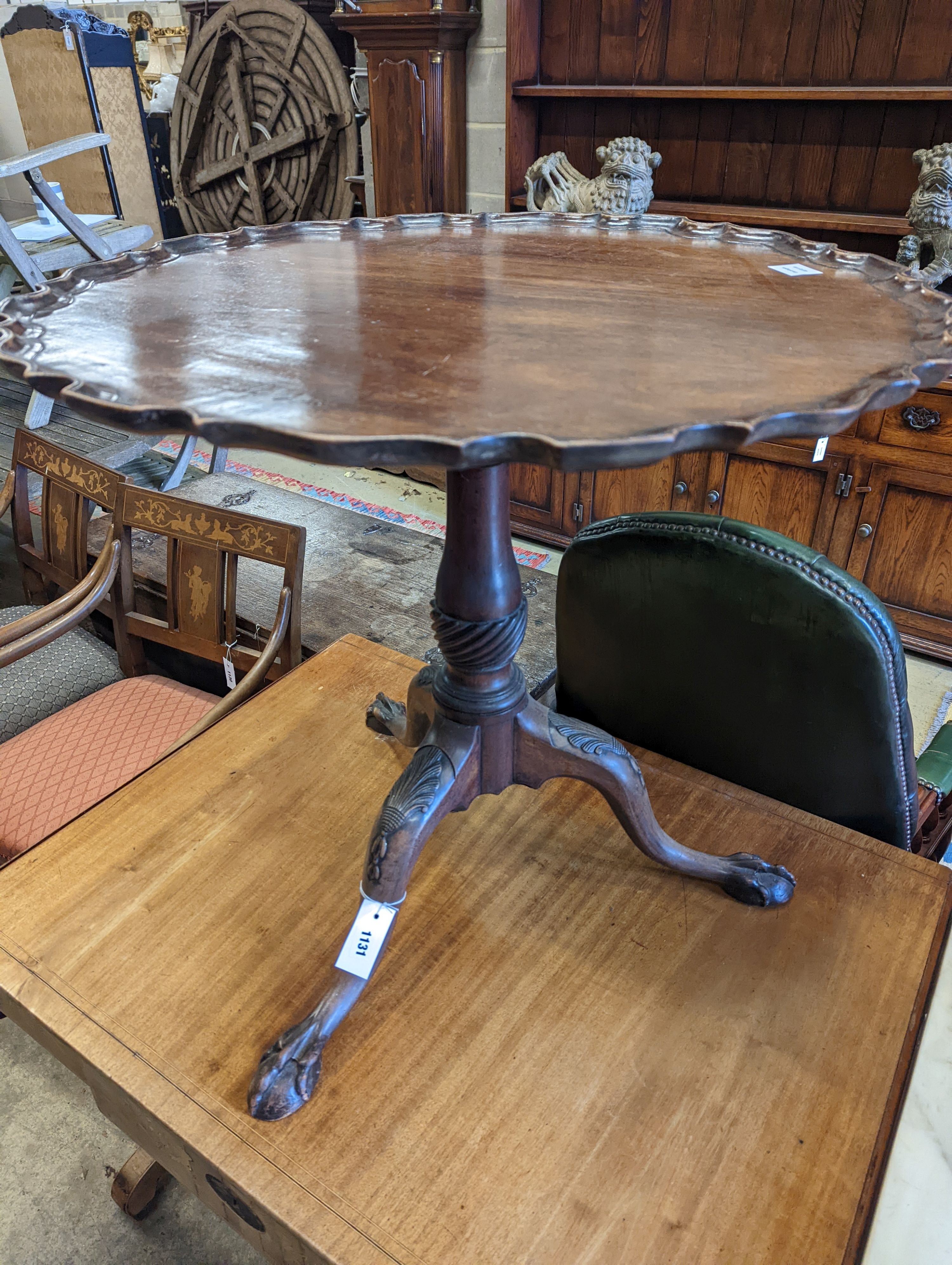 A George III style circular mahogany tripod table, with piecrust top and claw and ball feet, diameter 75cm, height 70cm